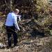 An Ann Arbor police officer surveys the area where the vehicle and body were found Thursday. Melanie Maxwell I AnnArbor.com
